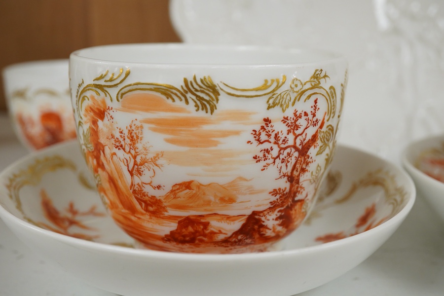 A 19th century Berlin part teaset, painted en camaieu in iron red, a Meissen vineous moulded dish and a Potschappel cache pot, Cache pot 12cm high.